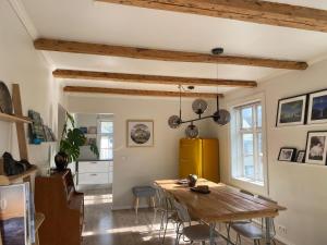 a dining room with a wooden table and chairs at Old Town Luxury Apartment Akureyri in Akureyri