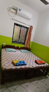 a small bed in a room with a window at Luiza Guest House in Baga +16 photos