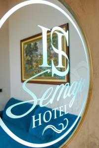 a sign for a luxury hotel in a mirror at Hotel Semajo in Vlorë