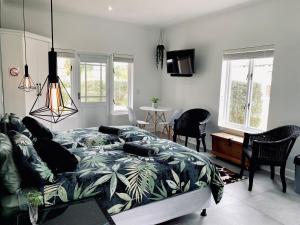 a living room with a bed and a couch at Sea-esta in Plettenberg Bay