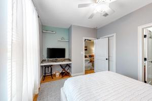 a bedroom with a bed and a flat screen tv at Topsail Village Away on Wildflower in Santa Rosa Beach