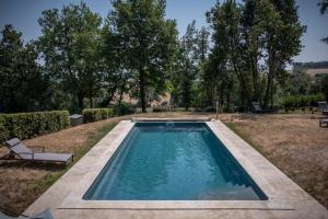a swimming pool in a yard with trees at Ty'Galis in Lectoure