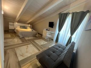a bedroom with a bed and a couch in a room at A La Puesta Del Sol in Agropoli +42 photos