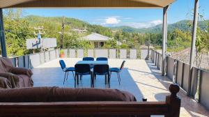 a patio with a table and chairs on a balcony at Belas House With Terrace in Kutaisi