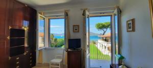 een kamer met een deur naar een balkon met een televisie bij Villa Playa del Sol - B1e1 in Saint-Tropez