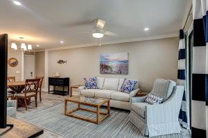 a living room with a couch and a table at Bend in the Road 2003 in Seabrook Island