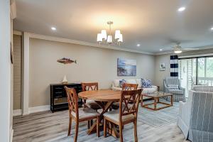 a dining room and living room with a table and chairs at Bend in the Road 2003 in Seabrook Island +33 photos