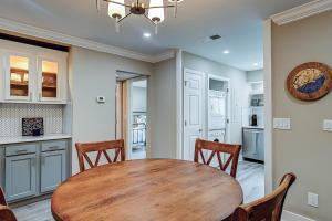 a kitchen and dining room with a wooden table and chairs at Bend in the Road 2003 in Seabrook Island
