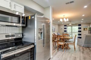 a kitchen with stainless steel appliances and a dining room at Bend in the Road 2003 in Seabrook Island