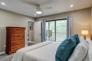 a bedroom with a white bed with a dresser and a window at Bend in the Road 2003 in Seabrook Island