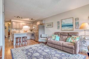 a living room with a couch and a kitchen at The Bullpen 129 in Neskowin +26 photos