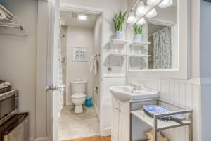 a white bathroom with a sink and a toilet at The Bullpen 129 in Neskowin