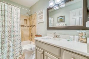 a bathroom with a sink and a toilet and a mirror at The Dugout #128 in Neskowin +26 photos
