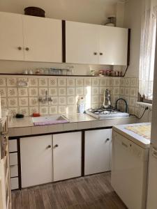 a kitchen with white cabinets and a counter top at Ağva Marina House in Istanbul