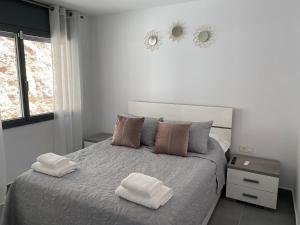 a bedroom with a bed with two towels on it at Lux Spa Barcelona in Vallirana +16 photos
