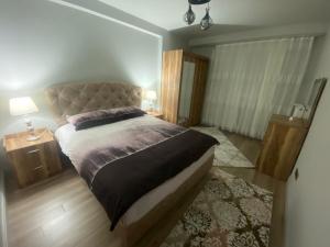a bedroom with a large bed and two night stands at شقة فاخرة بإطلالة رائعة in Buyukcekmece