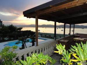 a resort with a swimming pool and a view of the water at Villa Playa del Sol - B2 in Saint-Tropez