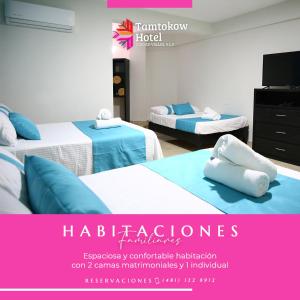 two beds in a room with a advertisement for a hotel at Hotel Tamtokow in Ciudad Valles