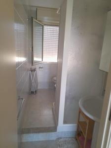 a bathroom with a shower and a toilet and a sink at Riviera la lanterna in Scoglitti