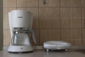 un frullatore bianco seduto su un bancone in cucina di Studio Nefeli a Archangelos Altre 14 foto