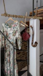 a dress and a purse hanging on a rail at sax & rosa in Pigna