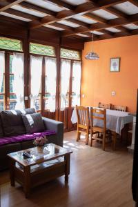 a living room with a couch and a table at Apartamentos Rurales Las Mestas in Puenteciella