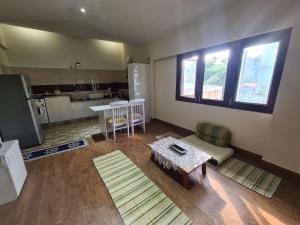 a living room with a couch and a table at Lychee Bungalow in Dehradun