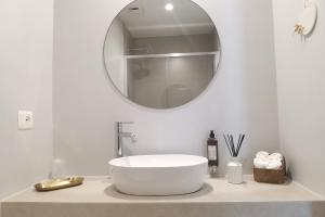 a white bathroom with a sink and a mirror at Vicolo Fiore Affittacamere II in Matera