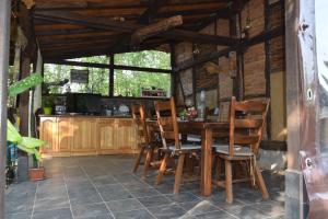 comedor con mesa de madera y sillas en Тихия кът en Malchovtsi