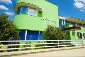 a green building with a sign on the side of it at Pensiunea Dolce in Timişoara