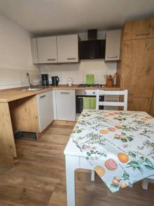 a kitchen with a table with a tablecloth on it at Sehr schöne seperate Wohnung 2-Zimmer Küche/Bad in Erzhausen