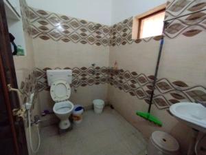 a bathroom with a toilet and a sink at Divine view - 1 bhk AC - Swarna Bhavan in Puri