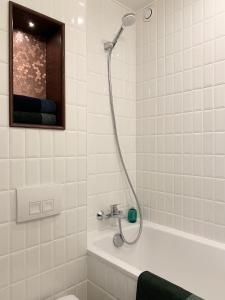 a bathroom with a shower and a bath tub at Chambre d’hôtes - Marais in Paris