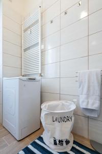 a bathroom with a washer and dryer and a toilet at Casa Martina- Airport free shuttle-H24 in Bergamo
