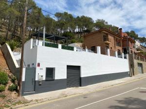 a white building on the side of a street at Lux Spa Barcelona in Vallirana