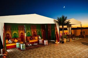 a tent with a table and chairs under it at Villa Arabic House Pool & SPA in Marrakesh