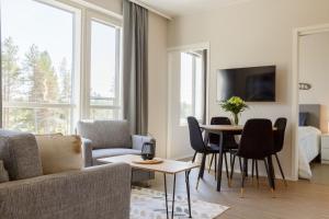 a living room with a couch and a table at Apartment Marinan Portti B37 kaksio Kalajoki in Kalajoki +9 photos
