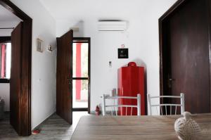 a living room with a red refrigerator in a room at Aris House - Cretan Hospitality in Agios Nikolaos