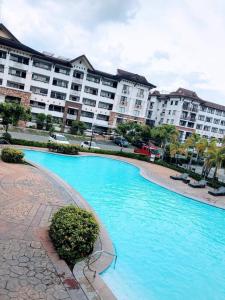 a swimming pool in front of a large apartment building at 1bedroom one oasis condo fullyfurnished in Davao City