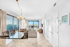 a dining room and living room with a table and chairs at SunDestin 101 in Destin