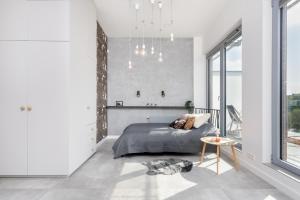 a bedroom with a bed and a large window at Kraków Loft in Krakow