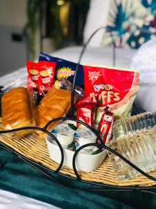 a basket of food and snacks on a table at MeeZee Pearl Double Bed Lodge With Free Parking in Manchester