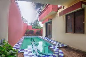 a swimming pool in the middle of a house at Hilltop 4 BHK Villa with Private Swimming Pool near Candolim in Old Goa