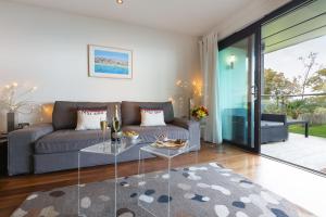 a living room with a couch and a glass table at Coast in St Ives