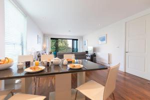 a dining room and living room with a table and chairs at Coast in St Ives