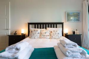 a bedroom with a bed with towels on it at Coast in St Ives