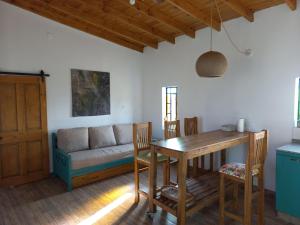 a living room with a table and a couch at Basilia - Casas de campo in Ruiz