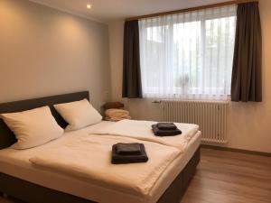1 dormitorio con 1 cama con 2 toallas negras en Gasthof Adler Äpfingen, en Äpfingen