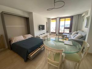 a bedroom with a table and a bed and a living room at Dernier Etage d'exception in Nice