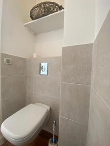 a bathroom with a toilet and a toilet brush at Dernier Etage d'exception in Nice